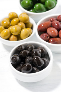 assortment of different kinds of organic olives, vertical closeup